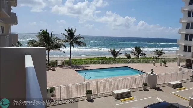 a view of swimming pool with outdoor seating and deck in the background