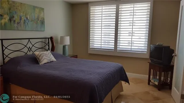 a bedroom with a bed and two windows