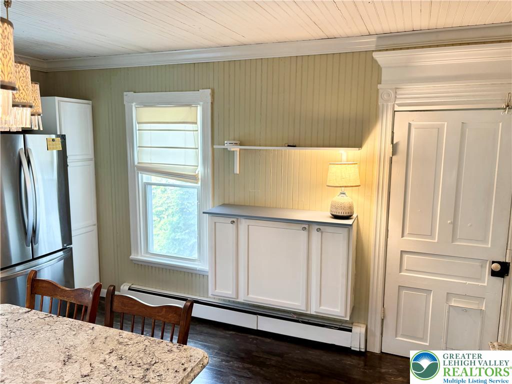 7241 Decatur Street New Tripoli, PA 18066 - Photo 4 of 36 A well-lit kitchen with classic paneling, rich flooring, and a window for natural light.