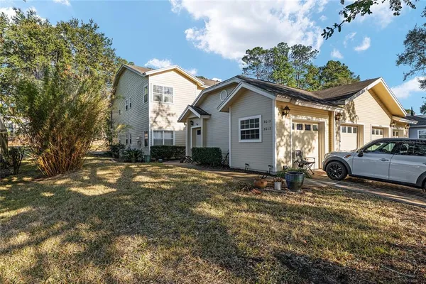 a view of a house with a yard and garage