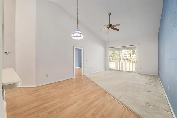 a view of an empty room with sliding glass door
