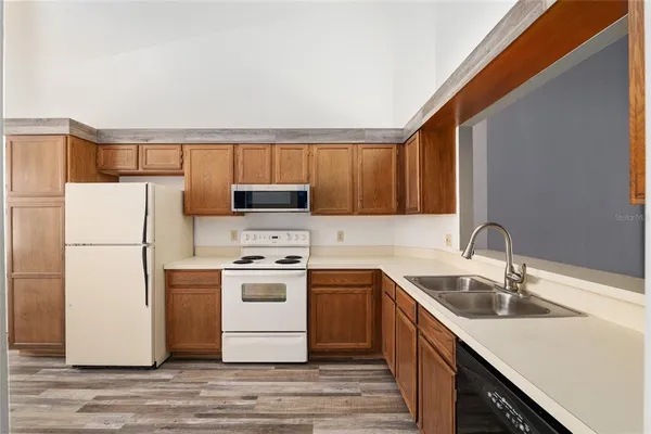 a view of kitchen with oven and refrigerator
