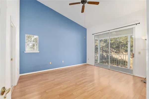 a view of a room with a window and a ceiling fan
