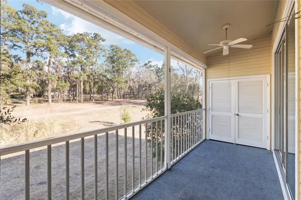 a view of a building with backyard and patio
