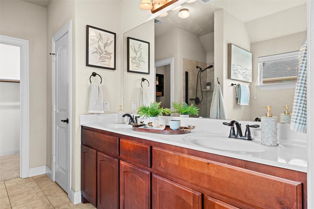 2322 Trace Ridge Drive Weatherford, TX 76087 - Photo 18 of 30 Full bath featuring double vanity, tiled shower, and light tile patterned floors