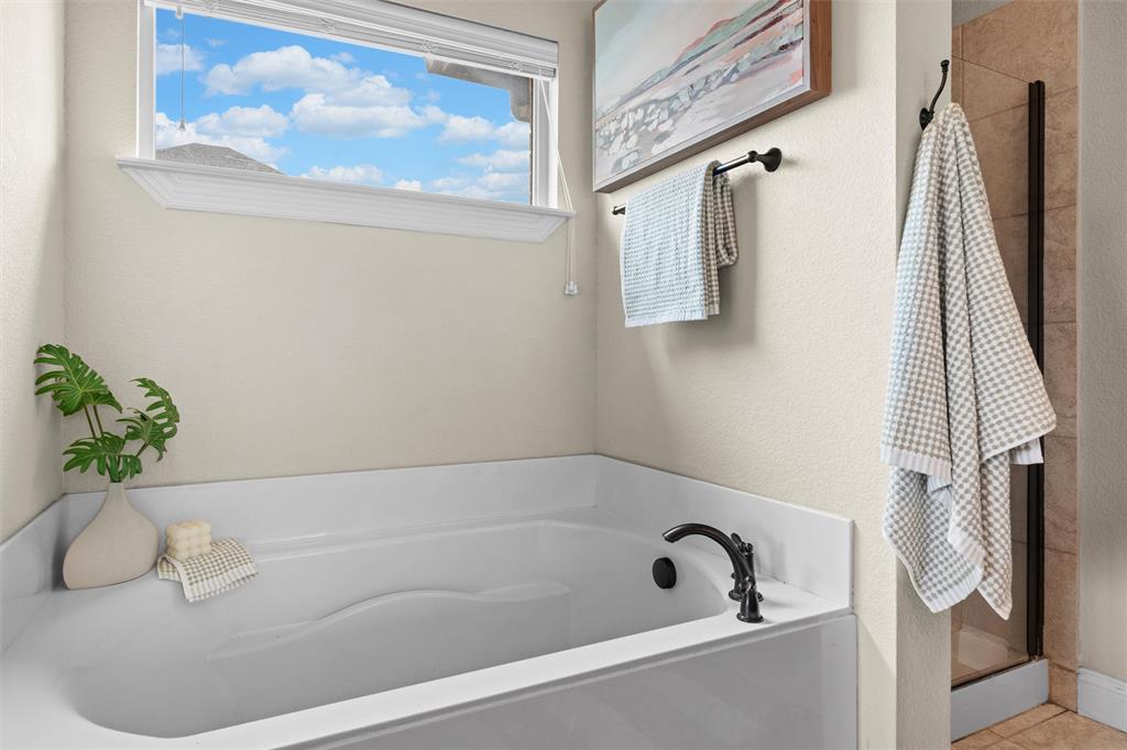 2322 Trace Ridge Drive Weatherford, TX 76087 - Photo 19 of 30 Full bath featuring double vanity, tiled shower, and light tile patterned floors