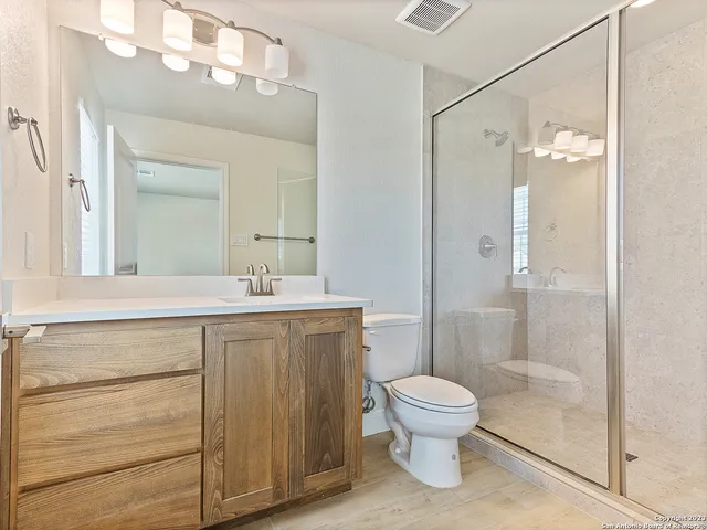 a bathroom with a toilet a sink and a mirror