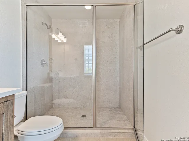 a bathroom with a glass shower door