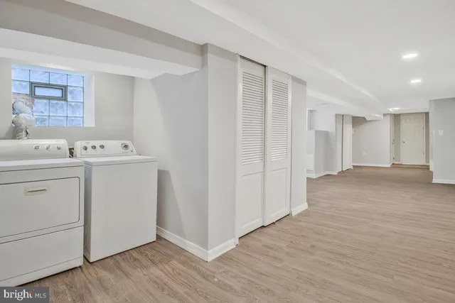 a view of a storage & utility room with a washer dryer