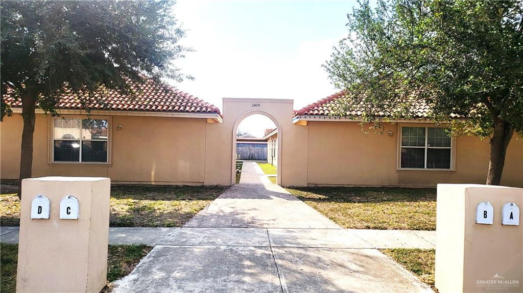 2405 Redbud Avenue McAllen, TX 78504 - Photo 1 of 5 a front view of a house with a garden