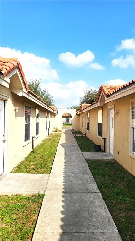 2405 Redbud Avenue McAllen, TX 78504 - Photo 2 of 5 a front view of a house with a yard and potted plants