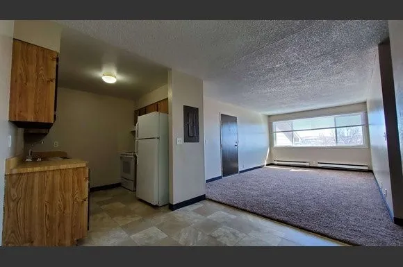 a view of a kitchen with refrigerator and microwave