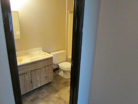 82 East Hayden Avenue, Unit 8 Evanston, WY 82930 - Photo 8 of 8 a bathroom with a granite countertop toilet and a sink