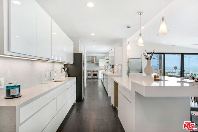 a large white kitchen with a lot of counter space