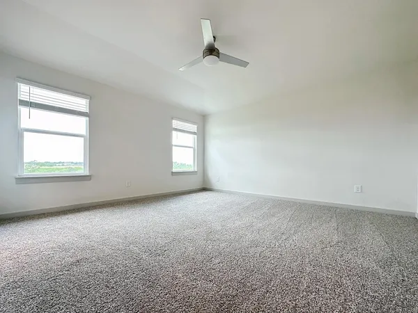a spacious bathroom with a granite countertop sink a toilet and shower