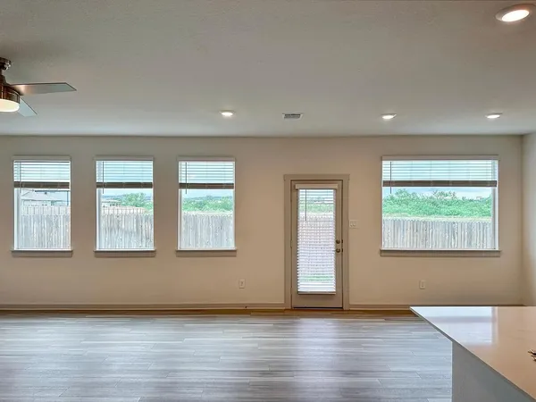 a view of kitchen with cabinets stainless steel appliances with wooden floor