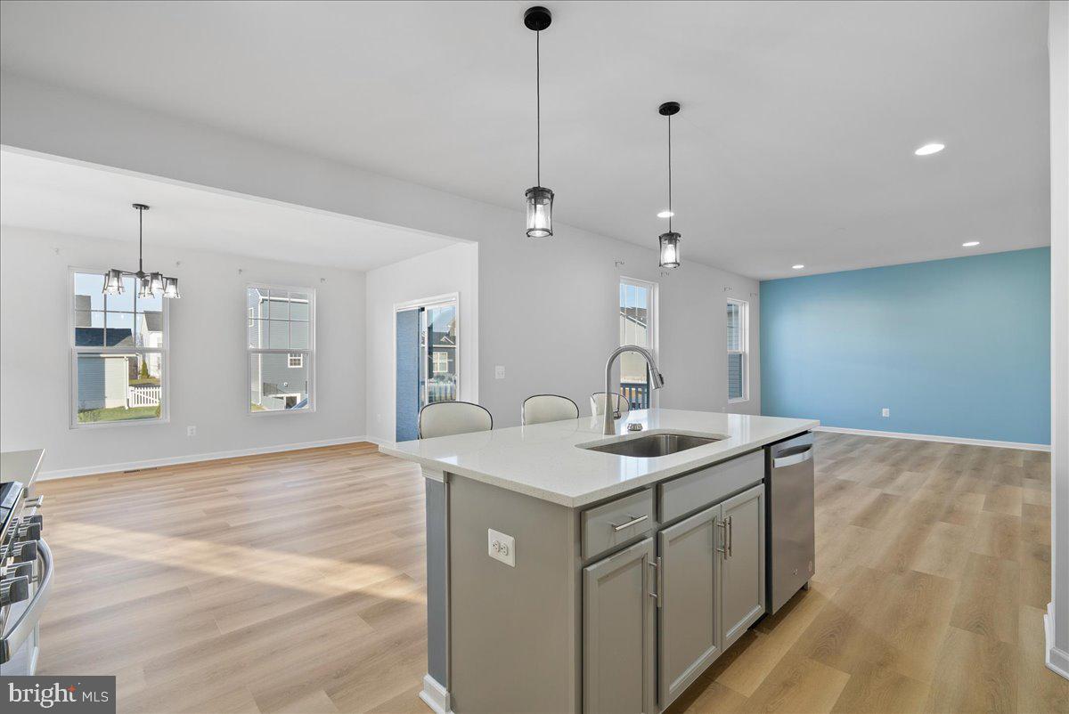115 Interlace Way Stephenson, VA 22656 - Photo 12 of 45 a kitchen with a sink a mirror and wooden floor
