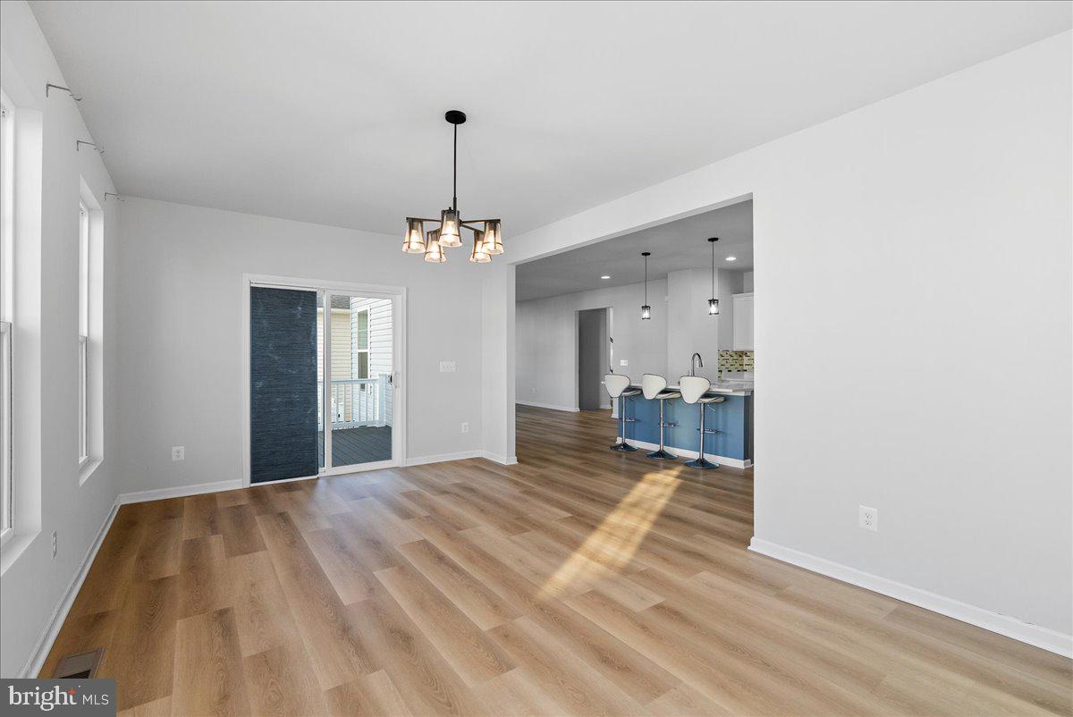 115 Interlace Way Stephenson, VA 22656 - Photo 15 of 45 a bedroom with a bed and a chandelier