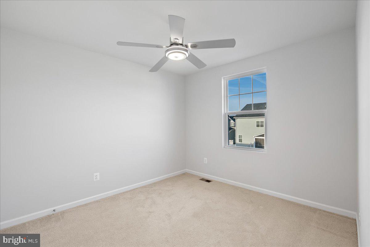 115 Interlace Way Stephenson, VA 22656 - Photo 23 of 45 an empty room with a window and ceiling fan