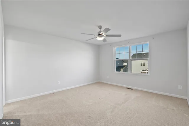 an empty room with a empty space and a ceiling fan