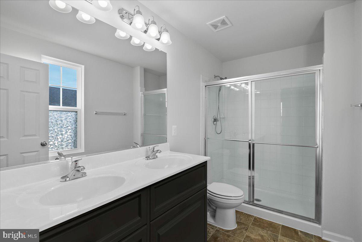 115 Interlace Way Stephenson, VA 22656 - Photo 29 of 45 a bathroom with a double vanity sink toilet and a mirror