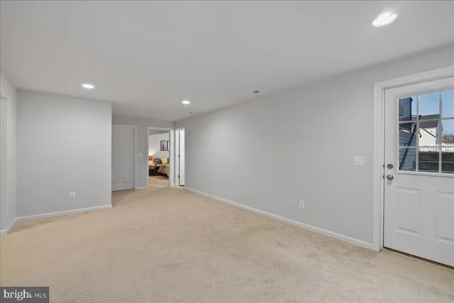 an empty room with closet and windows