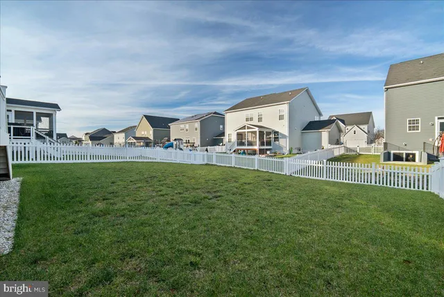 a view of a house with patio and yard