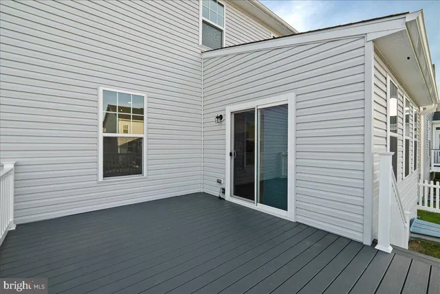 a view of a house with wooden deck