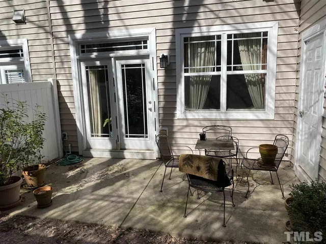 a view of house with backyard and sitting area