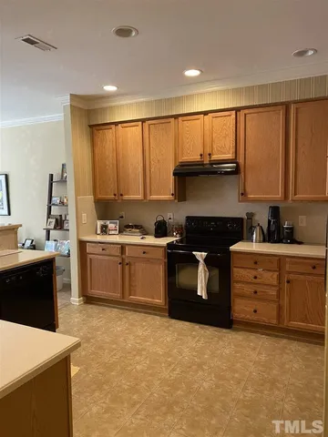 a kitchen with stainless steel appliances kitchen island granite countertop a stove a sink and a refrigerator