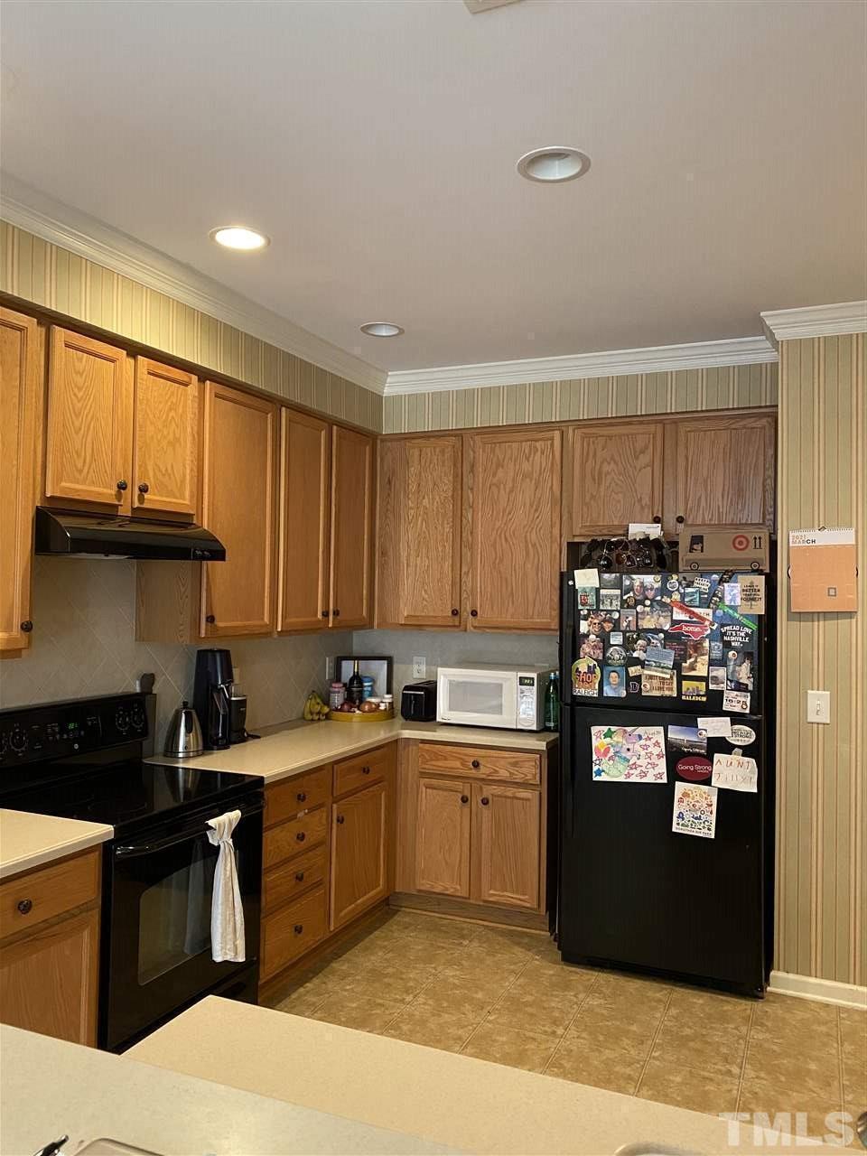 4705 Lawhorn Street Raleigh, NC 27606 - Photo 7 of 9 a kitchen with a sink and cabinets