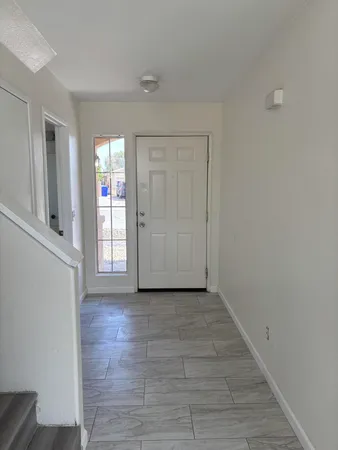 a view of a livingroom with a ceiling fan and window