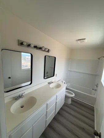 a bathroom with a sink a toilet and bathtub