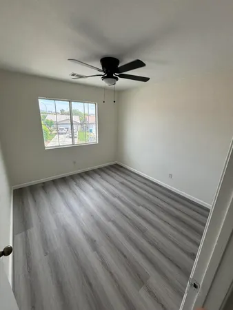 a view of a closet with wooden floor