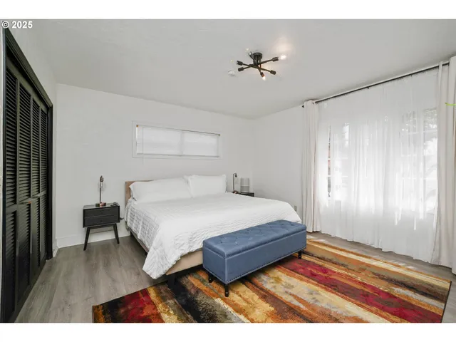 a bedroom with a bed and a mirror