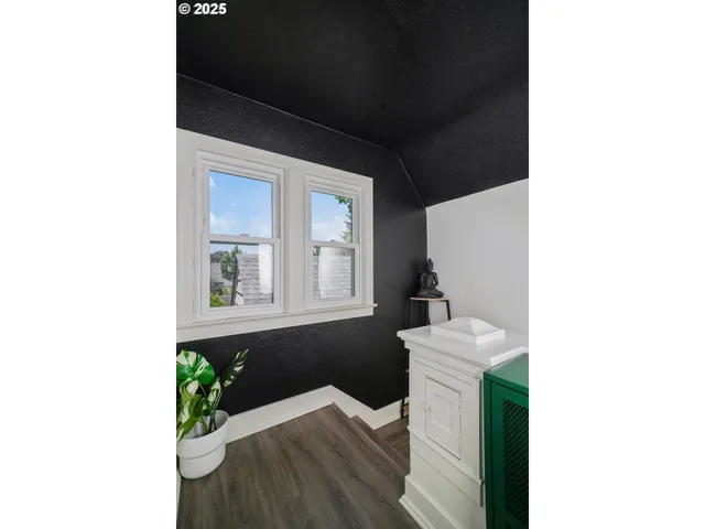 a bathroom with a potted plant and a shower