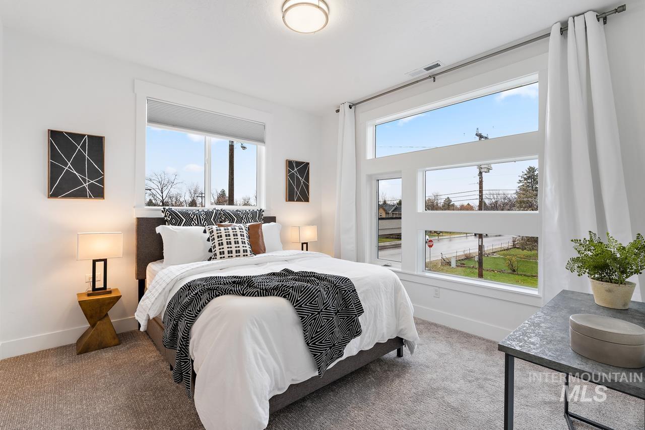 599 West Warren Street Boise, ID 83706 - Photo 39 of 41 Bright interior featuring extensive windows, white walls, and neutral-toned carpeting