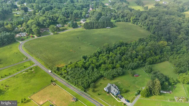 an aerial view of a residential houses with swimming pool and outdoor space