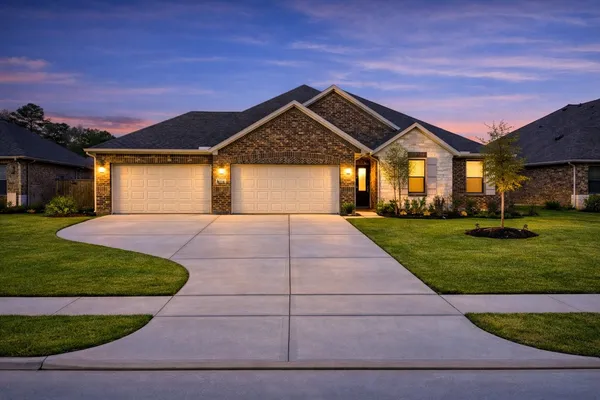 a front view of house and yard with green space
