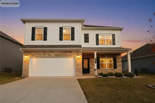 a front view of a house with a yard