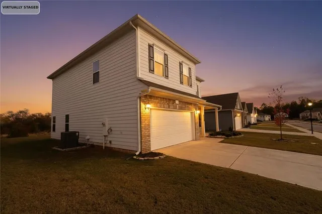 a front view of a house with a yard