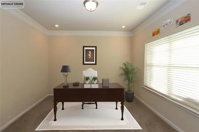 a view of a workspace with furniture and a window