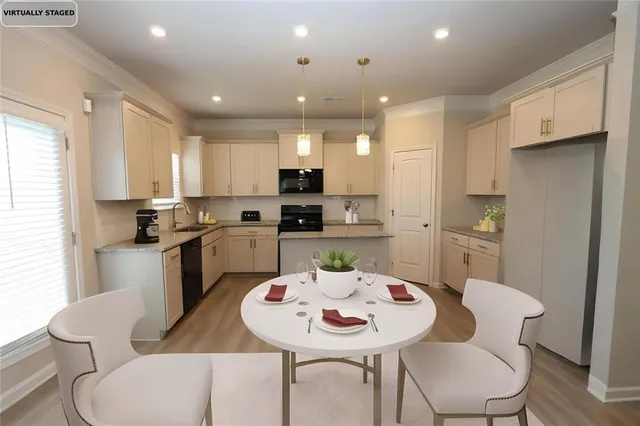 a kitchen with a dining table chairs and white appliances