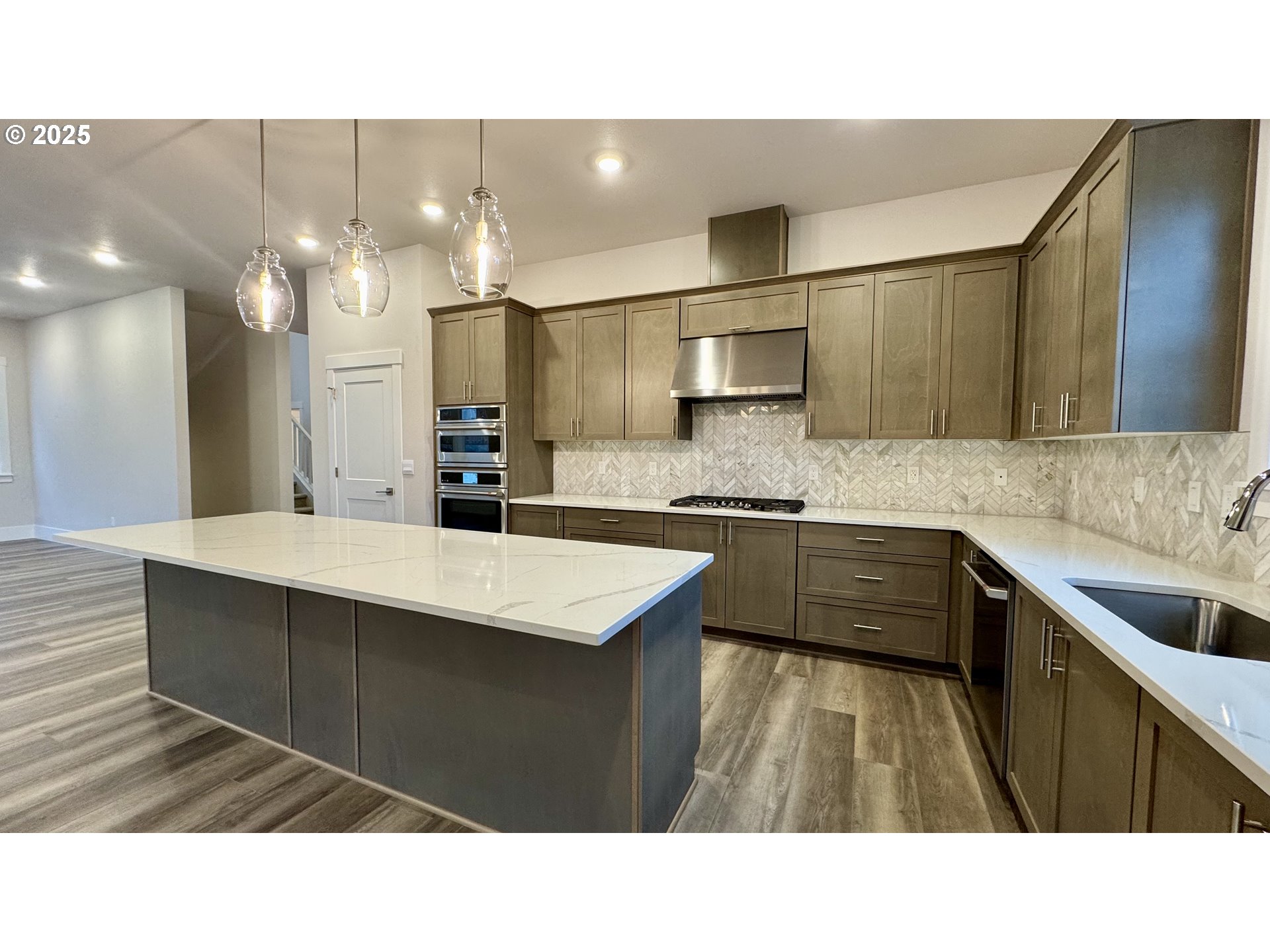 11728 Southwest Hayrick Terrace Beaverton, OR 97007 - Photo 15 of 25 a kitchen with kitchen island granite countertop a sink window and stainless steel appliances