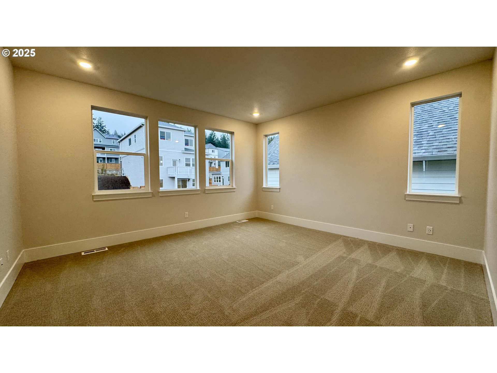 11728 Southwest Hayrick Terrace Beaverton, OR 97007 - Photo 19 of 25 a open hall with a floor to ceiling window and wooden floor