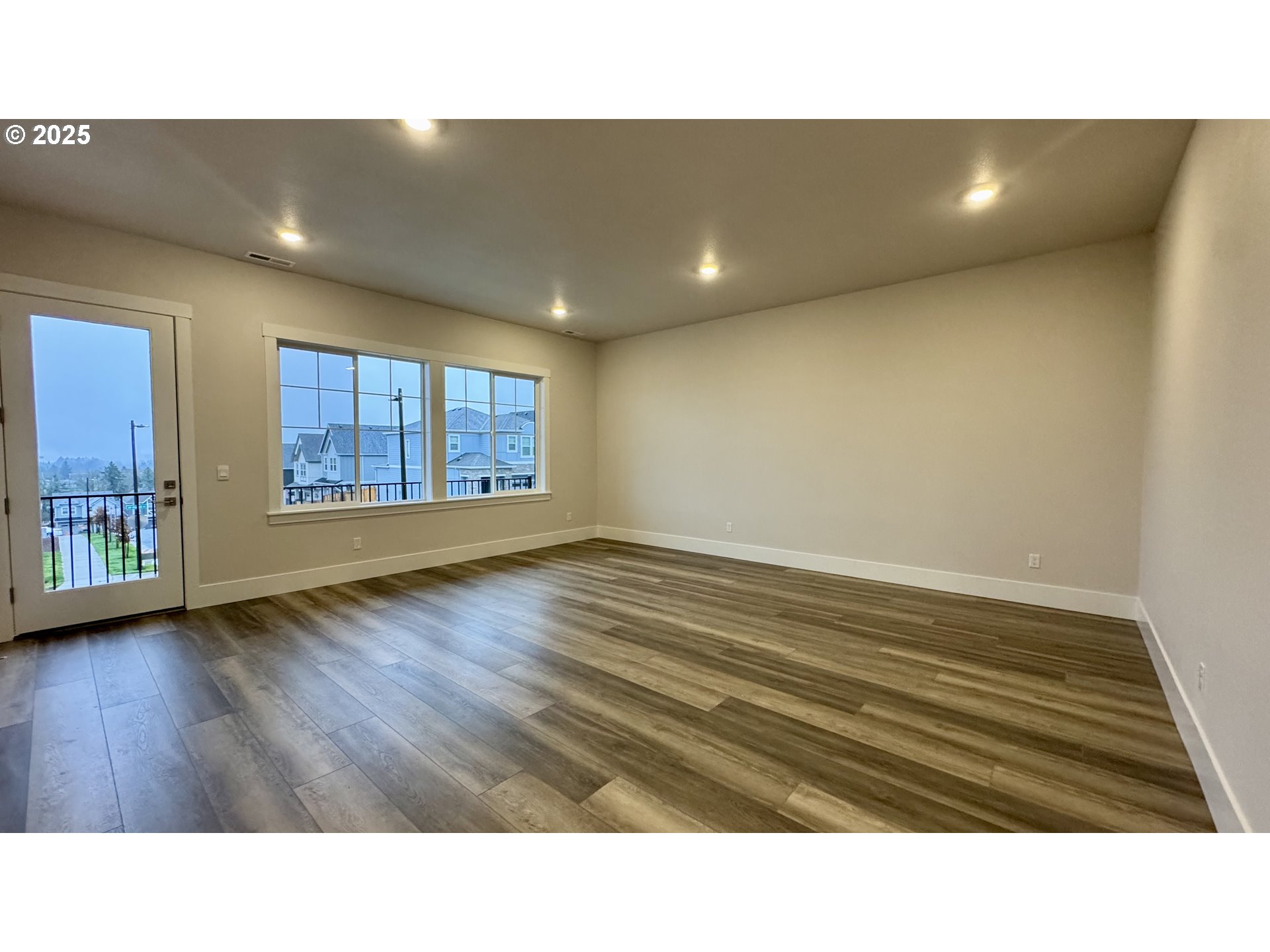 11728 Southwest Hayrick Terrace Beaverton, OR 97007 - Photo 6 of 25 a open hall with wooden floor and brick walls