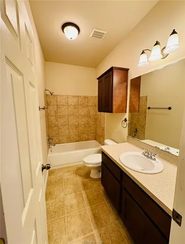 a bathroom with a tub sink and mirror