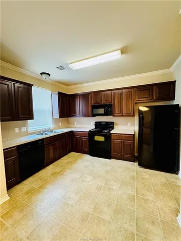 a kitchen with stainless steel appliances a refrigerator and a sink