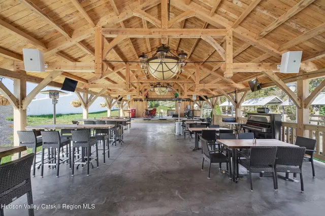 a view of a big room with tables and chairs