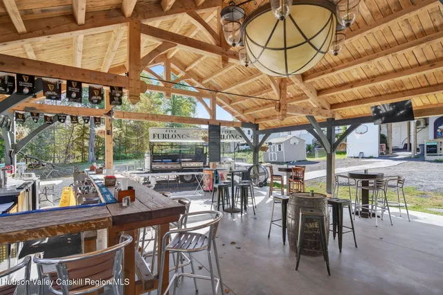 a view of a white house with a big yard and large trees
